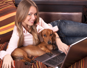 girl blond  working with laptop home, and dog dachshund